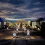Local Berber family standing near their traditional mudbrick home.