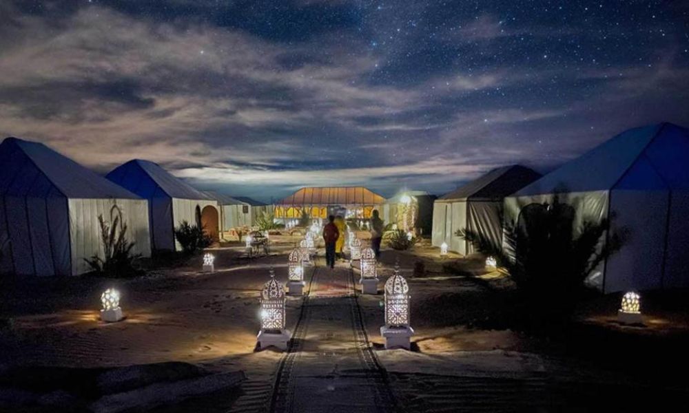 Local Berber family standing near their traditional mudbrick home.
