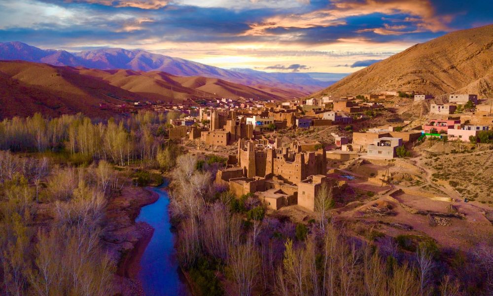High Atlas Valley Morocco – Scenic Views on Marrakech to Fes Desert Tour Lush valley in the High Atlas Mountains, Morocco, with Berber villages and winding roads during a 4-day Marrakech to Fes desert tour